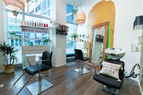 a hair salon with chairs and mirrors