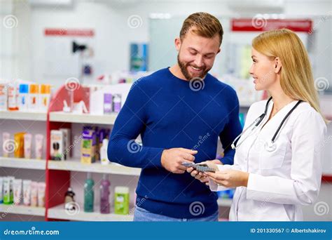 Caucasian Friendly Pharmacist Has A Nice Conversation With A Client