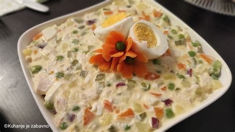 An Egg And Vegetable Casserole Is Served On A White Plate With A Flower