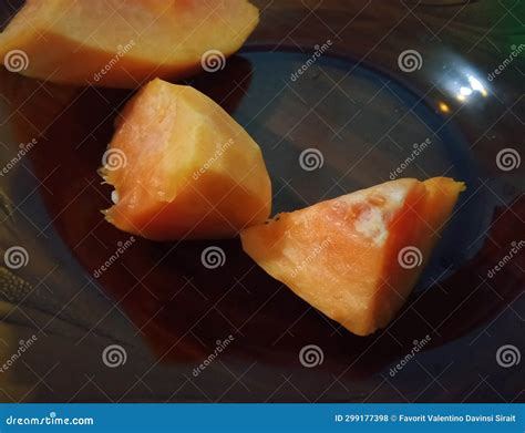 Pieces of Papaya Fruit with Orange Color on the Brown Background Stock ...