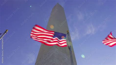 A Static Shot With A Lens Flare Of Flags Waving In The Wind In Front Of