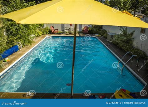 Yellow Umbrella and Water Pool Stock Image - Image of patio, fence ...