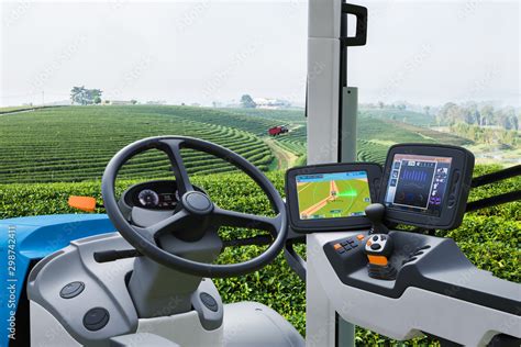 Autonomous tractor working in green tea field, Future technology with smart agriculture farming ...