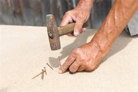 To Hammer A Nail With A Hammer Older Worker Carpenter Stock Photo