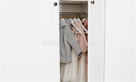 Hangers with Stylish Clothes for a Girl in the White Closet Stock Image ...