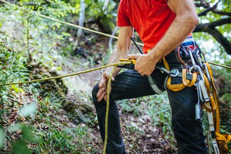 Mountain Rescuer Securing Ropes To Climb Stock Photo Adobe Stock