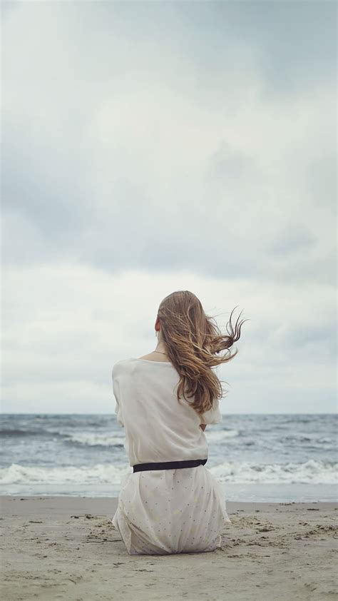 Girl Sitting Alone On Beach