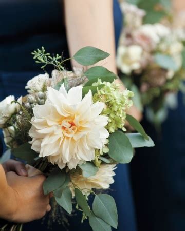 The Bridesmaids Are Holding Their Bouquets With White And Green Flowers