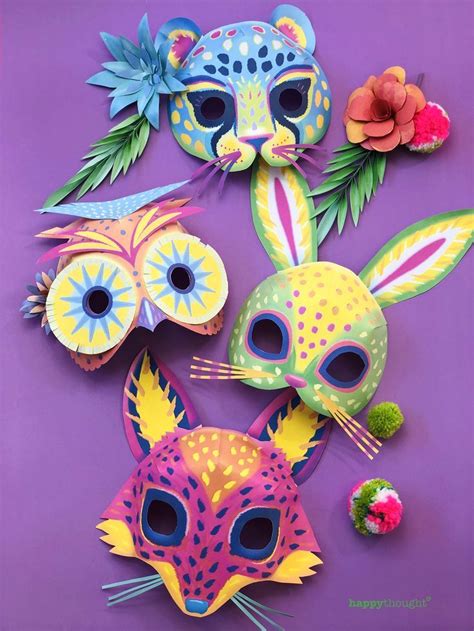 Three Masks With Different Designs And Colors On Purple Paper One Has