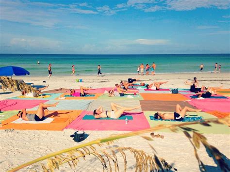 many people are doing yoga on the beach