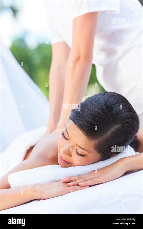 An Asian Chinese Woman Relaxing Outside At A Health Spa While Having A