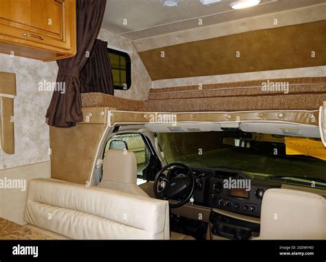 motorhome interior, cab, cabover bed, dinette cushioned seat, driver's ...