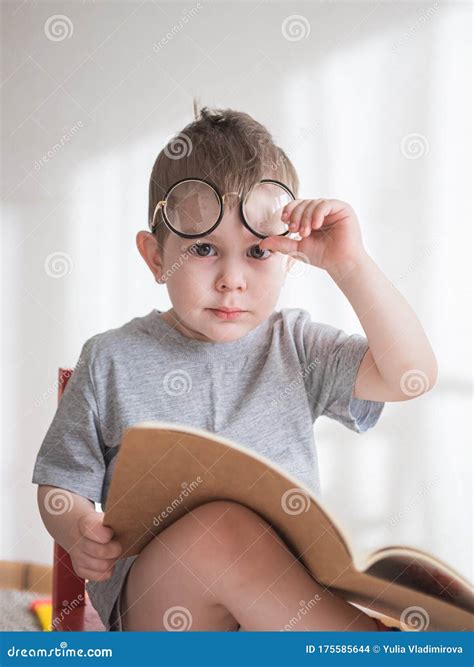 Cute Toddler Boy Reading A Book In Glasses Smart Preschooler Stock