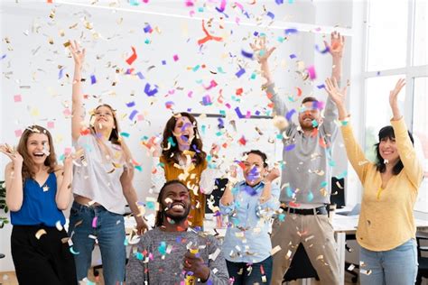 Premium Photo | Excited people celebrating with confetti