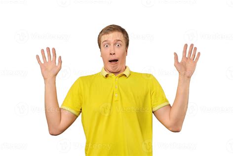 Scared young man with hands up in yellow Polo T-shirt, white isolated background 13406594 Stock ...