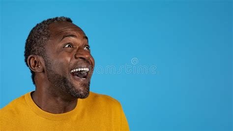 Excited Emotional African American Mature Man Looking At Copy Space