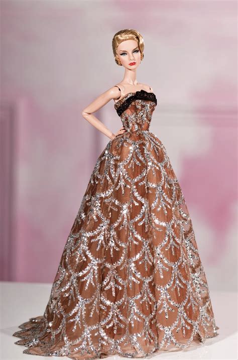 A Barbie Doll Wearing A Brown And Silver Dress With Sequins On The Skirt