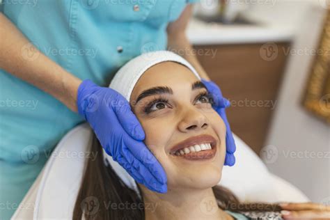 Masseur Giving Treatment To Beautiful Brunette Close Up Portrait Of A Young Beautiful Girl