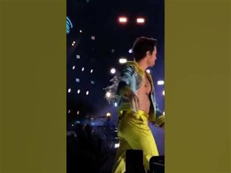 A Man In Yellow Is Walking On Stage