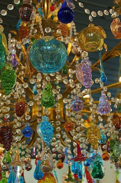 A Chandelier With Many Different Colored Glass Pieces Hanging From It S