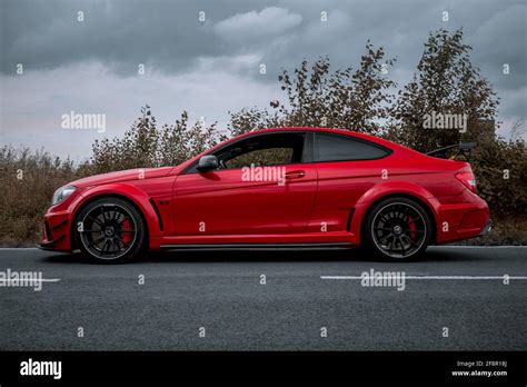 The Side Profile Of A 2012 Red Mercedes Benz C63 AMG Black Series W204 On A Overcast Day In ...