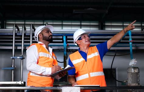 Chief Engineer Of A Mechanical Plant Inspecting And Explaining The