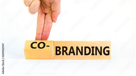 Branding or co-branding symbol. Businessman turns wooden cubes and ...