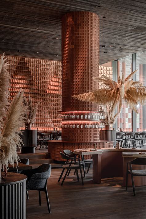 The Interior Of A Restaurant With Tables Chairs And Palm Trees In