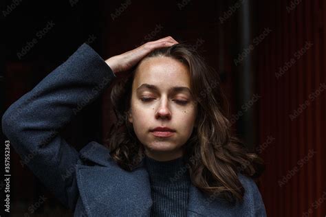 Closeup On Young Thoughtful Pretty Girl In Gray Coat And Turtleneck