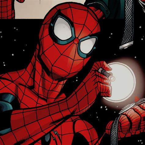 A Spider Man Holding A White Ball In His Right Hand And Looking At It