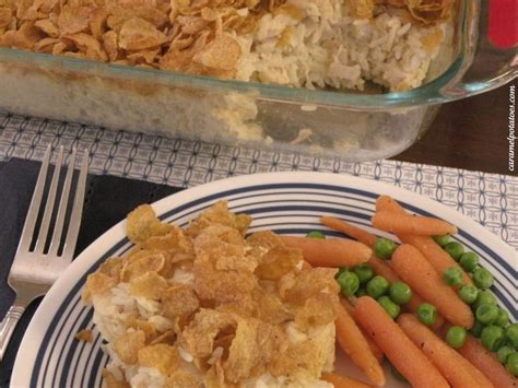 A Plate With Carrots And Peas Next To A Casserole Dish On A Table