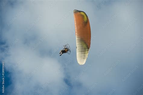 Paramotor flying over the fields in the sky. Stock Photo | Adobe Stock