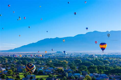 Hot Air Balloons Flying With The Sandia Mountains In Background At