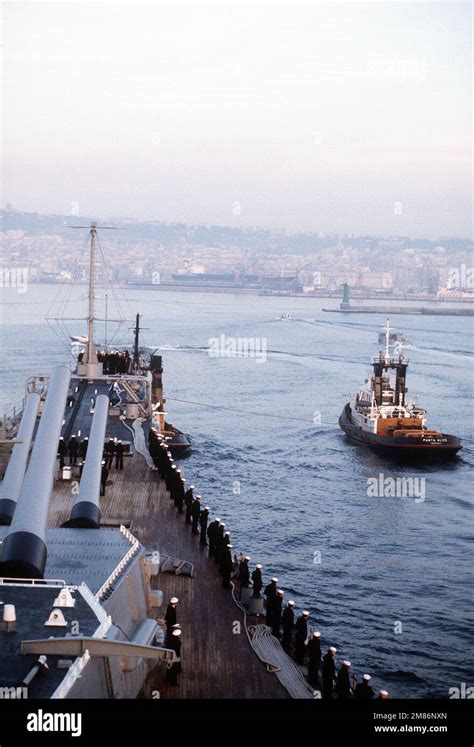 Crew Members Aboard The Battleship Uss Missouri Bb Man The Rails