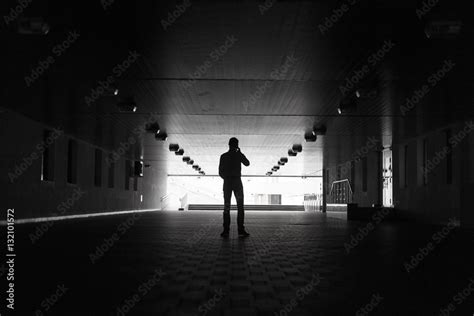 Dark Silhouette Of A Man Making An Anonymous Phone Call Stock Photo