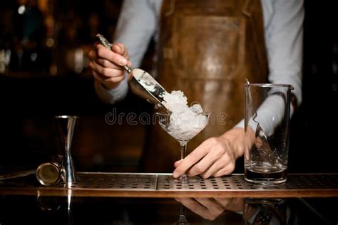 Professional Male Bartender Putting Crushed Ice To The Glass Stock