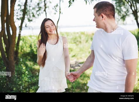 Happy And Young Pregnant Couple Hugging In Nature Romantic Moments