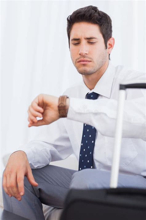 Serious Businessman With His Baggage Waiting For A Flight Stock Photo