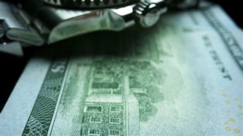 Wristwatch Lying On One Hundred Dollar Banknote US Cash Money Stock