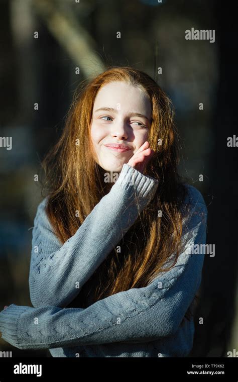 Portrait Of Cute Twelve Year Old Girl With Fiery Red Hair Posing In The