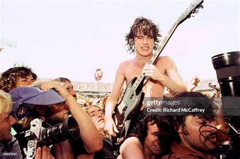 Angus Young and Bon Scott of AC/DC get swept away by fans and media ...