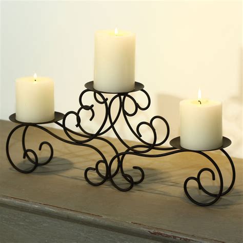 This Sleigh Style Candle Holder Displays Three Pillar Candles Of Any