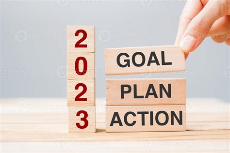 Hand Holding Wooden Block With Text 2023 Goal Plan And Action On Table