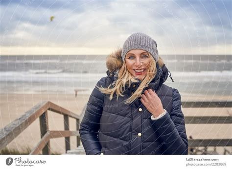 Middle Aged Woman Braving A Cold Winter Day At The Sea A Royalty Free