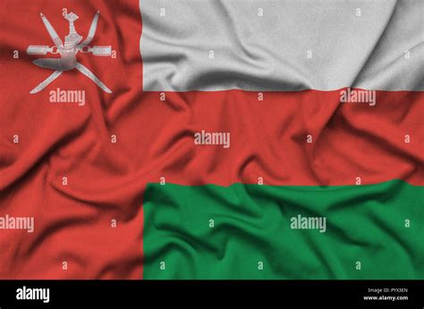 Oman Flag Is Depicted On A Sports Cloth Fabric With Many Folds Sport