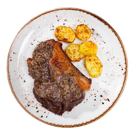 Tasty Roasted Beef Meat With Fried Potatoes Served On Table Stock Photo