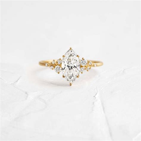 Snowdrift Ring With A Marquise Cut Diamond And Cluster Band