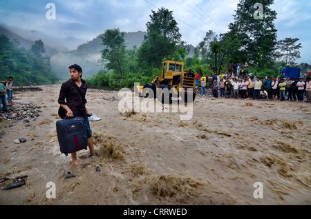 A Man Wades Across A Flooded Road Near The Colorado River Friday May