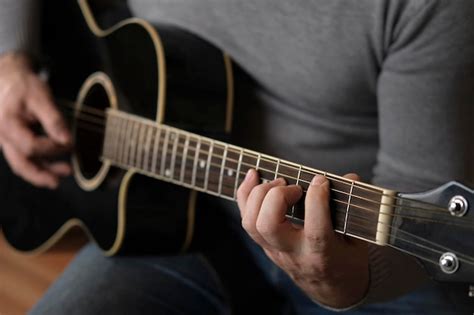 Premium Photo Playing The Guitar Strumming Black Acoustic Guitar