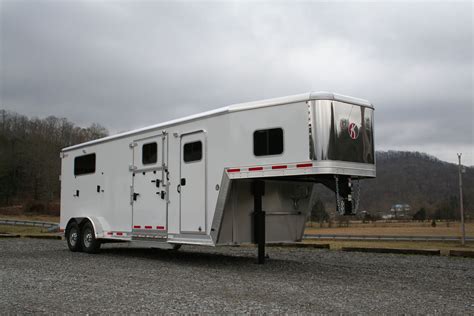 A Horse Trailer Is Parked On The Gravel